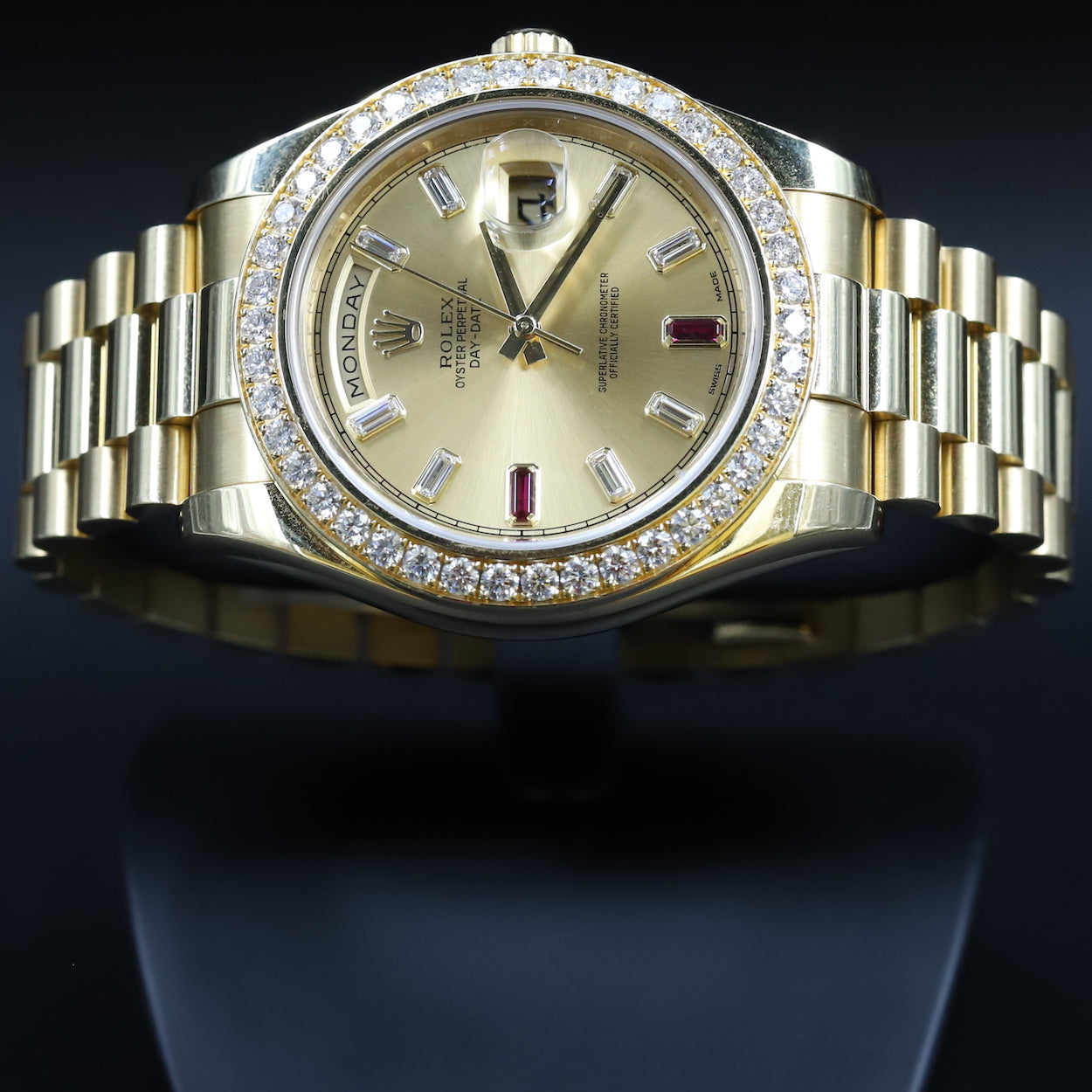 Rolex218348 DayDate II Ruby Dial Diamond Bezel Newport Watch Club